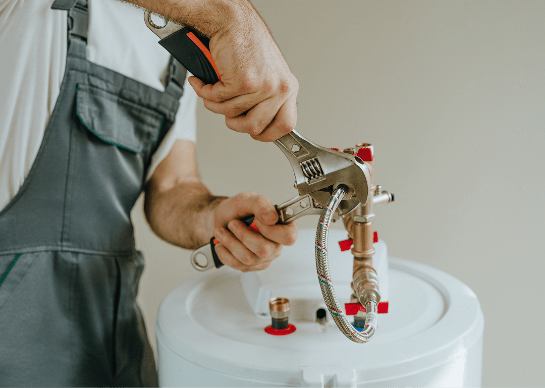 Plumber fixing water heater pipes